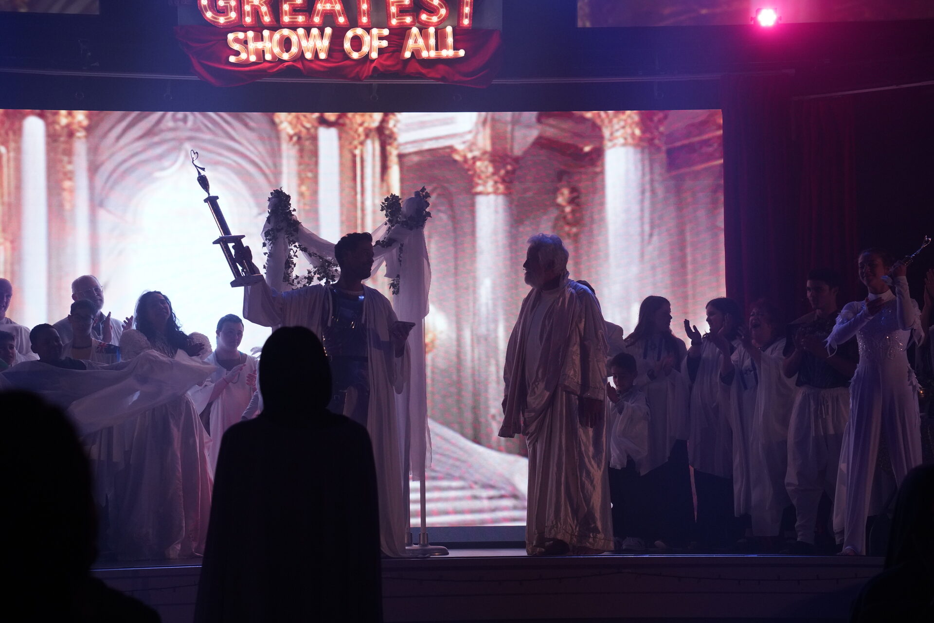 The full cast in a golden finale scene