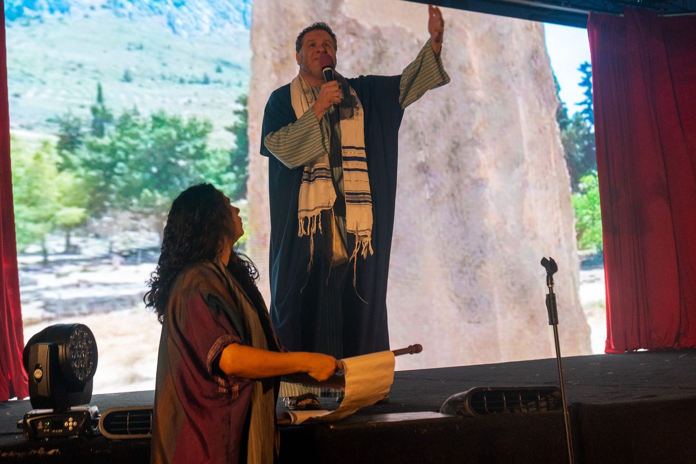 An actor in a prayer shawl proclaiming Scripture during The Greatest Show of All